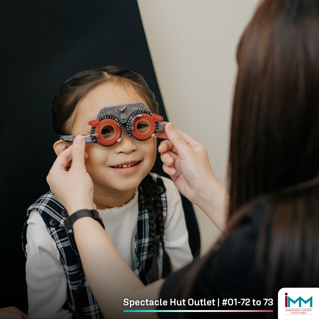 Multiple generations trying on glasses in an optical store