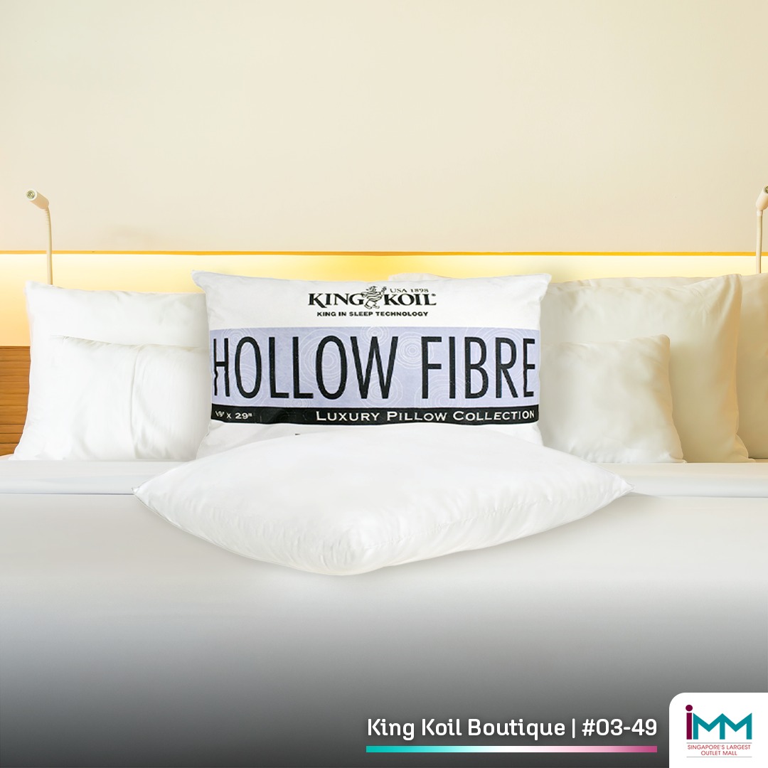 A perfectly made bed with plush pillows and a comfortable mattress, inviting a restful night's sleep.