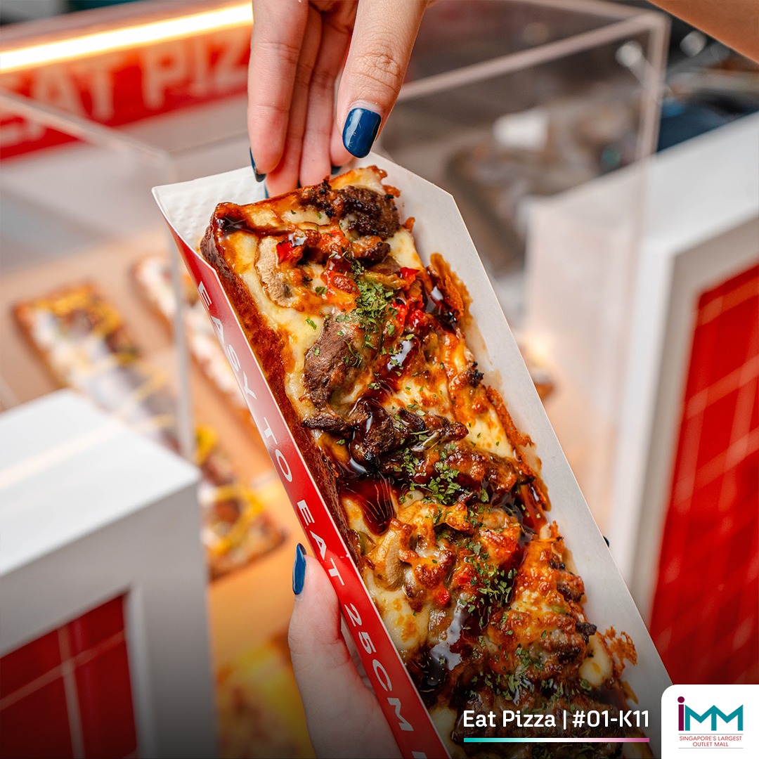 A close-up of a freshly baked pizza slice from Eat Pizza Singapore