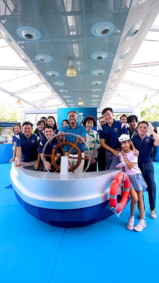 Group photo at Voyage Beyond maritime exhibition at IMM with ship model display