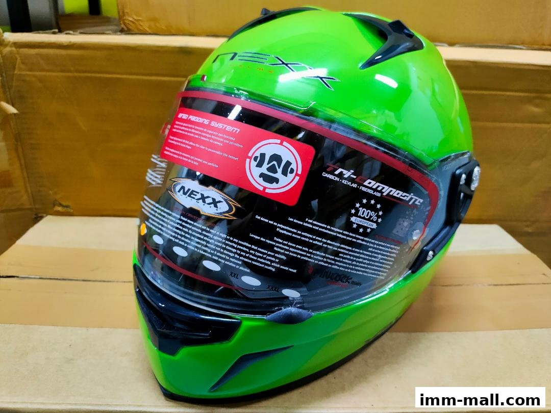 A bright green Nexx motorcycle helmet with detailed product information on the visor.