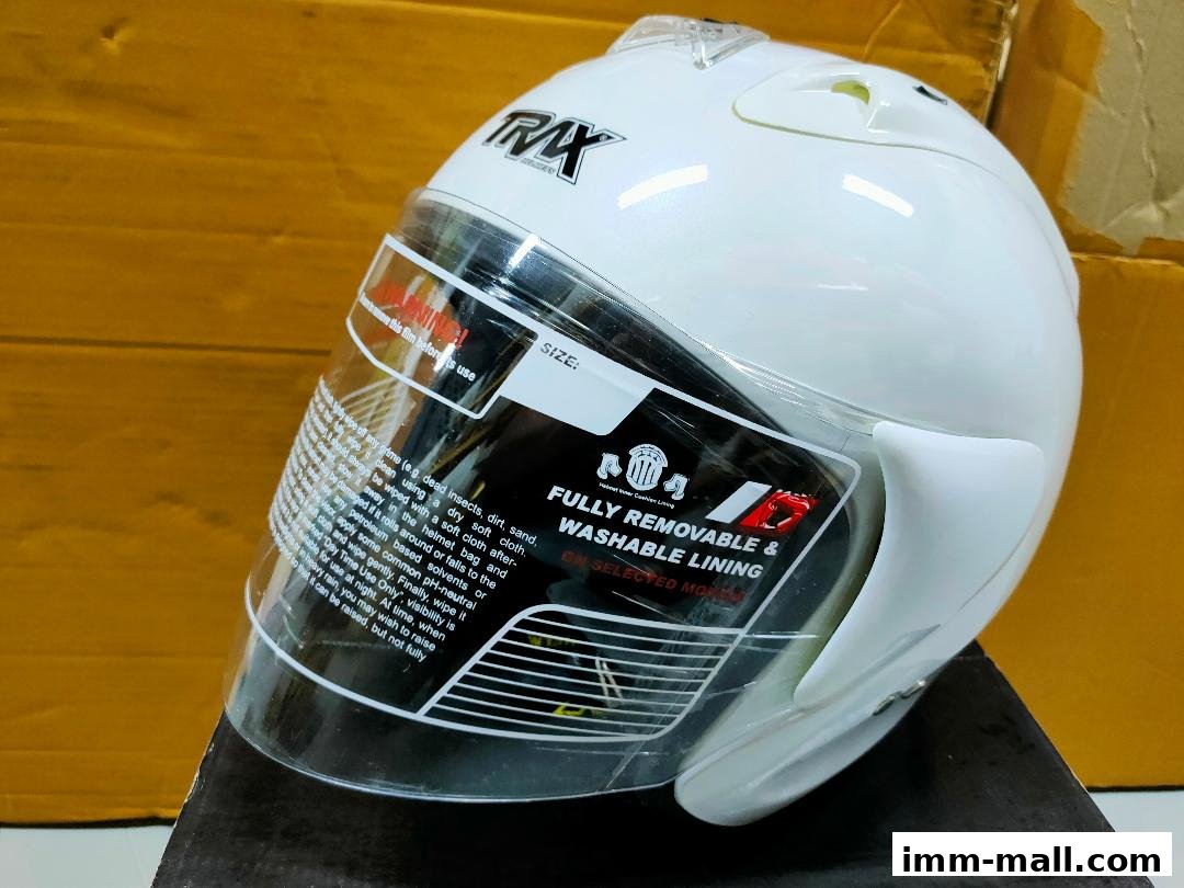 A white motorcycle helmet with a clear visor and detailed care instructions on the visor.