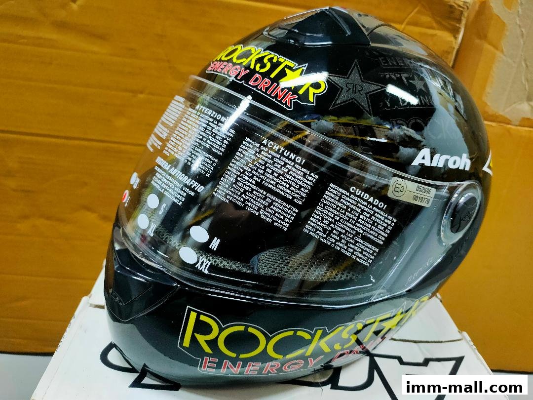 A black Airoh motorcycle helmet with Rockstar Energy Drink branding.