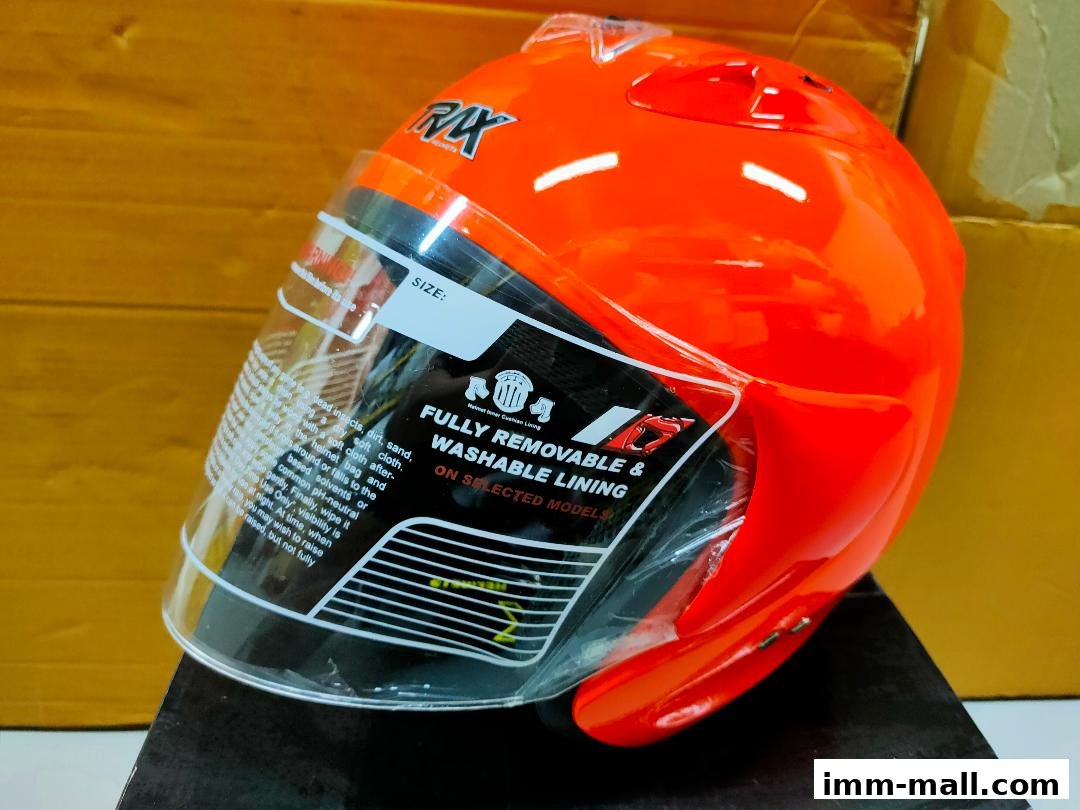 A bright orange motorcycle helmet with a clear visor and removable lining.