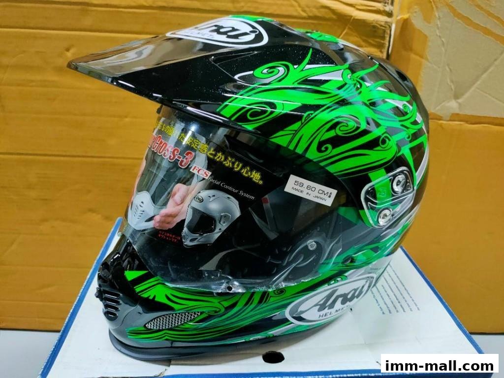 A black and green Arai motorcycle helmet with a visor and detailed graphics.