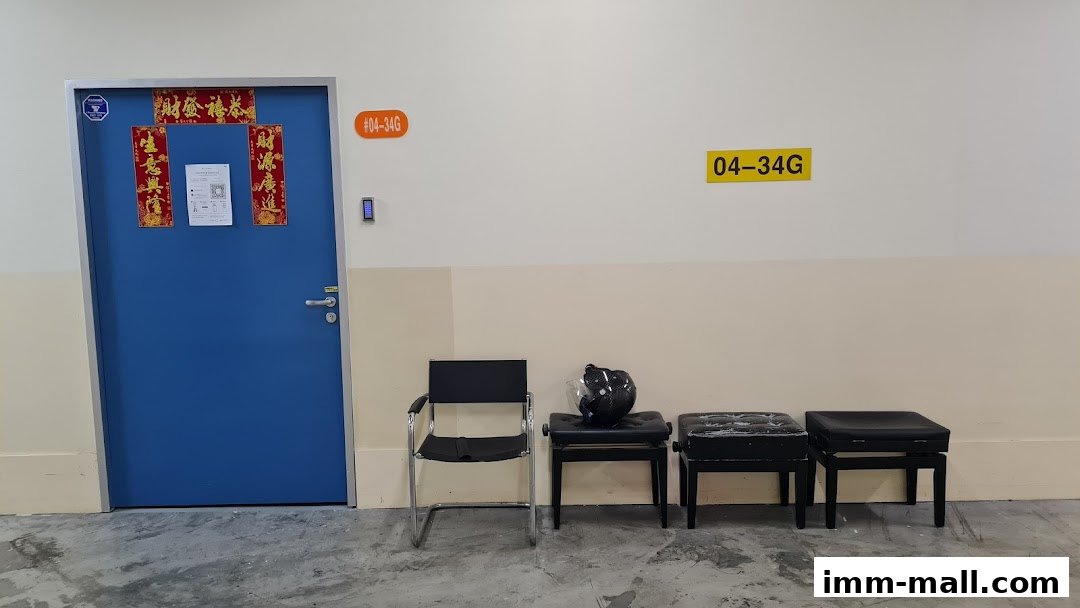 A blue door with Chinese New Year decorations and seating outside a shop unit.