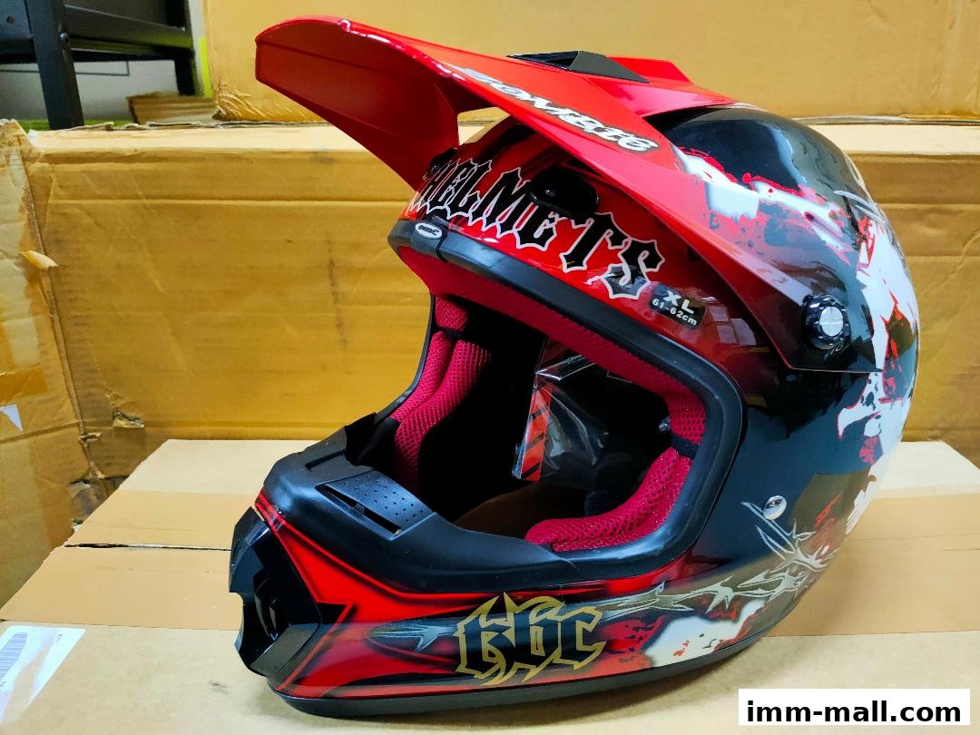 A red and black motocross helmet with a graphic design and red interior.