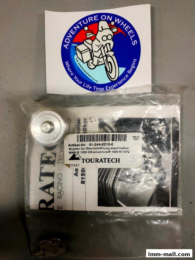 A sticker and a packaged motorcycle part from Adventure On Wheels.