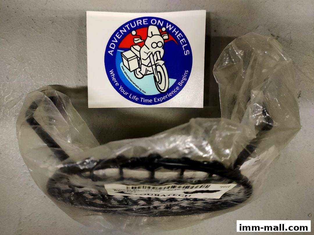 A sticker and a motorcycle luggage rack in plastic packaging.