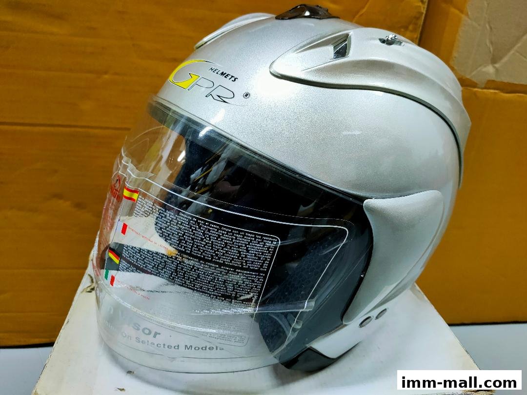 A silver motorcycle helmet with a clear visor and 'GPR HELMETS' branding.