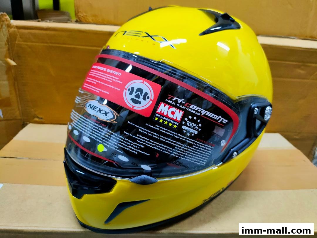 A bright yellow motorcycle helmet with detailed branding and safety information.