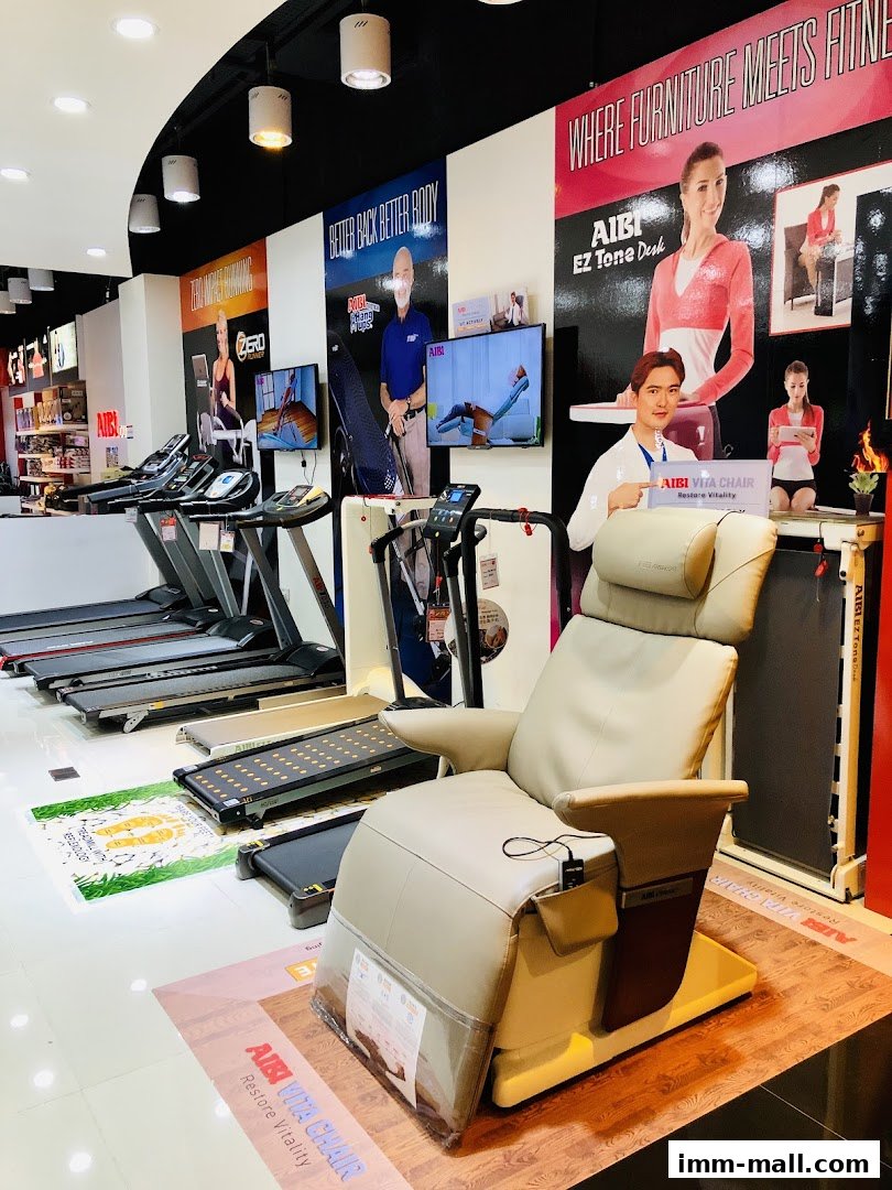 Interior of an AIBI fitness store showcasing treadmills and a massage chair.