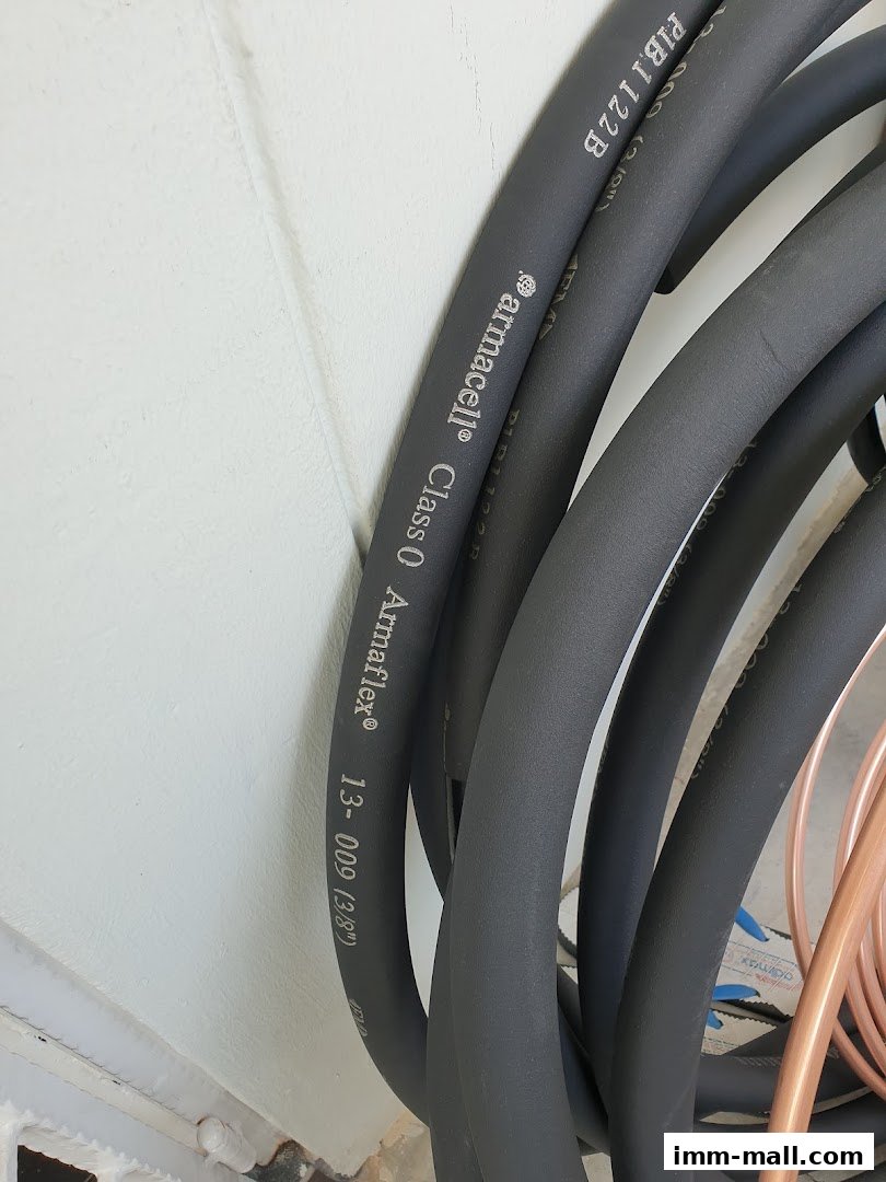 Close-up of black insulation tubing with text indicating brand and specifications.