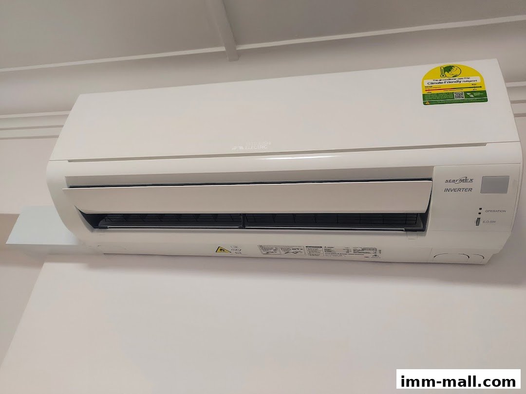 A white Mitsubishi Electric air conditioner unit mounted on a white wall.