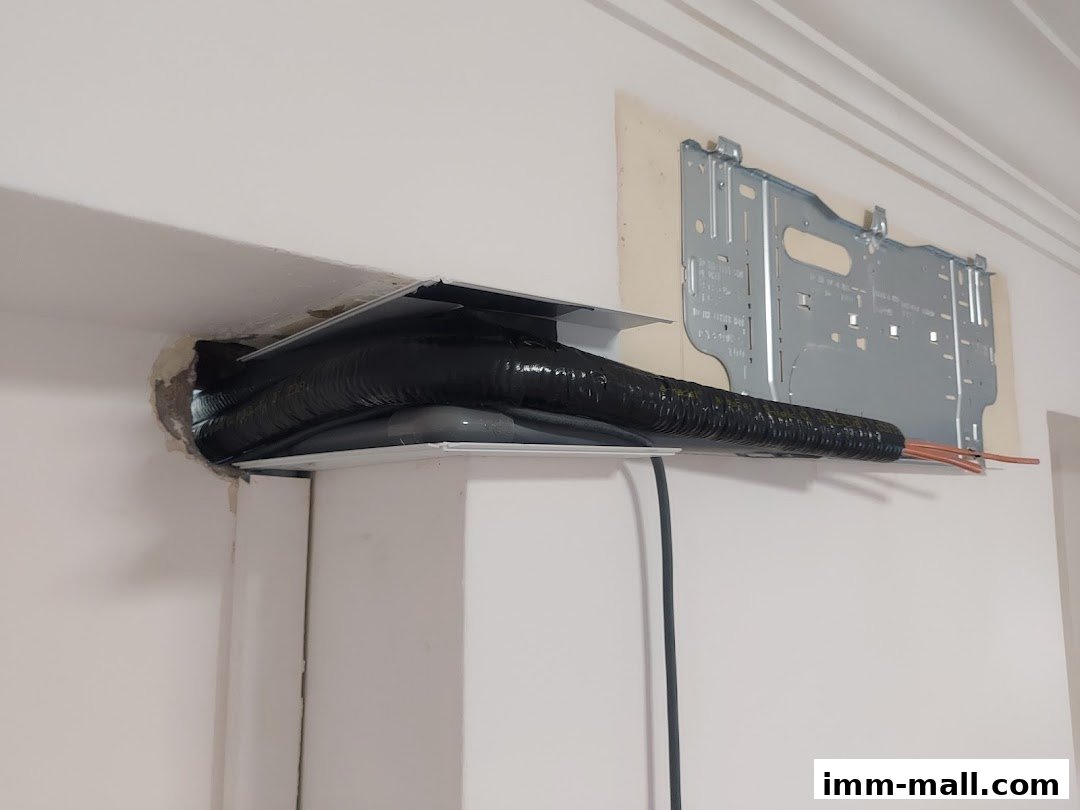 Close-up of air conditioning pipes and mounting bracket during installation.