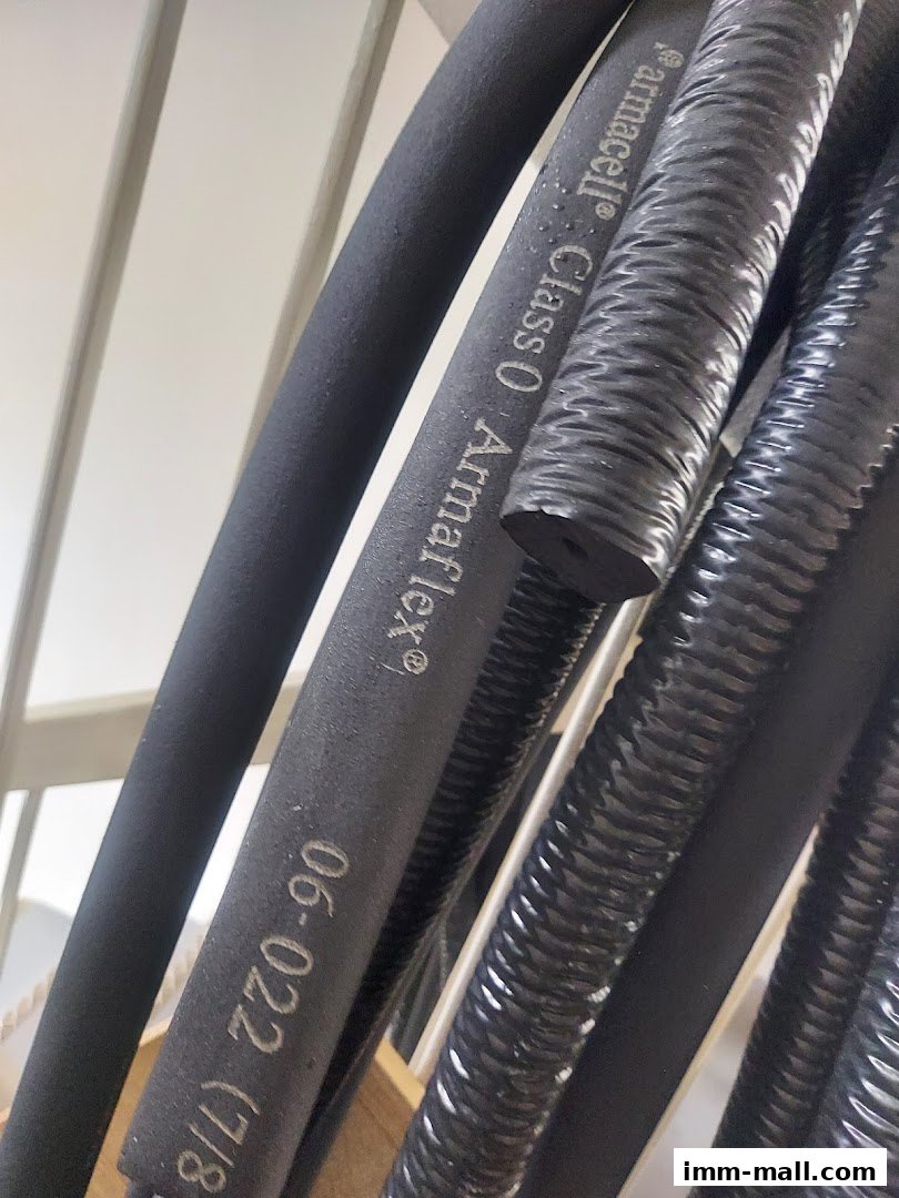 Close-up of black insulation tubes, some with text indicating brand and specifications.