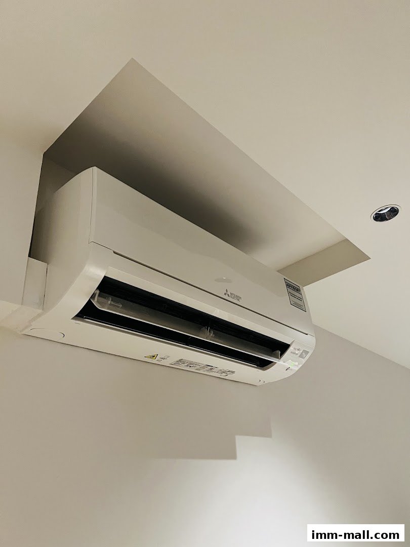 A modern split air conditioning unit installed in a recessed ceiling.