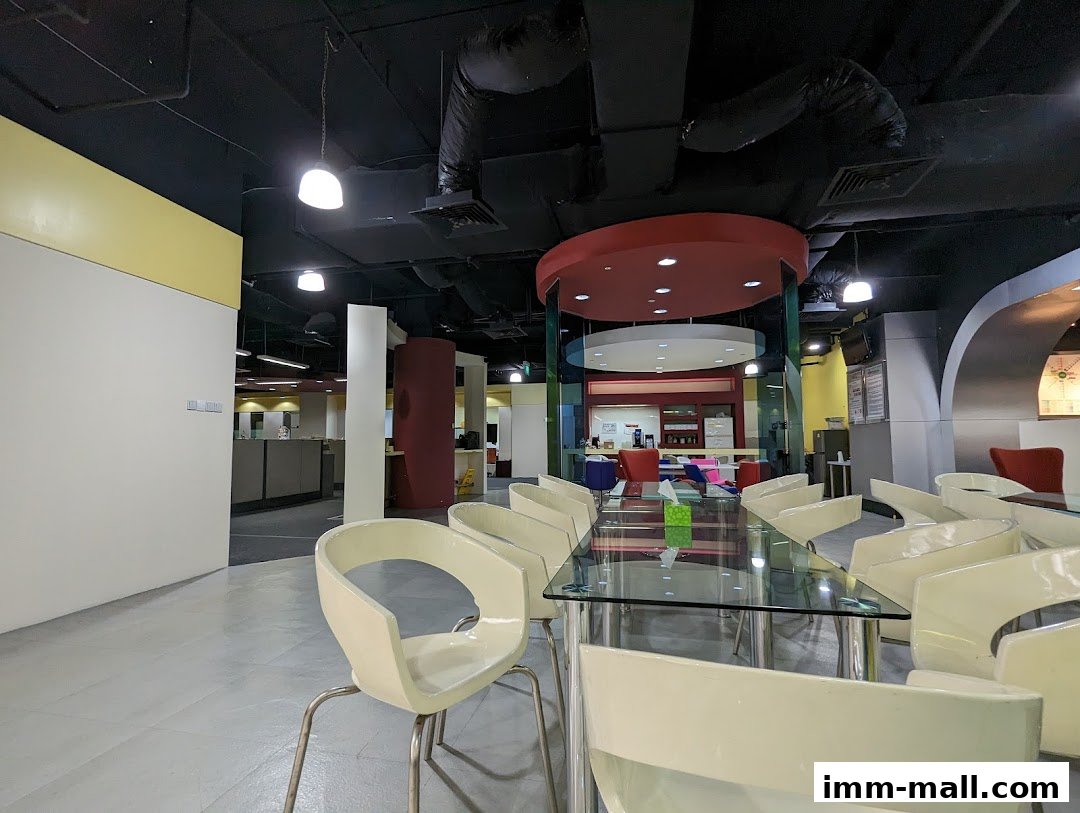 Interior view of a modern office space with a dining table and chairs.