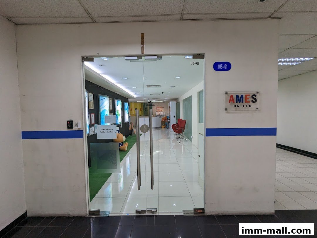 The entrance to Ames United Pte. Ltd. with glass doors and company signage.