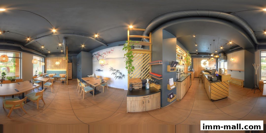 Interior view of a modern restaurant with wooden tables, chairs, and a counter.