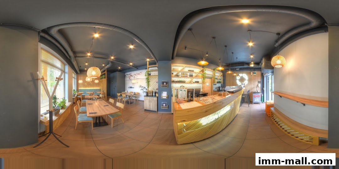 Interior view of a modern restaurant with wooden tables, chairs, and a prominent counter.