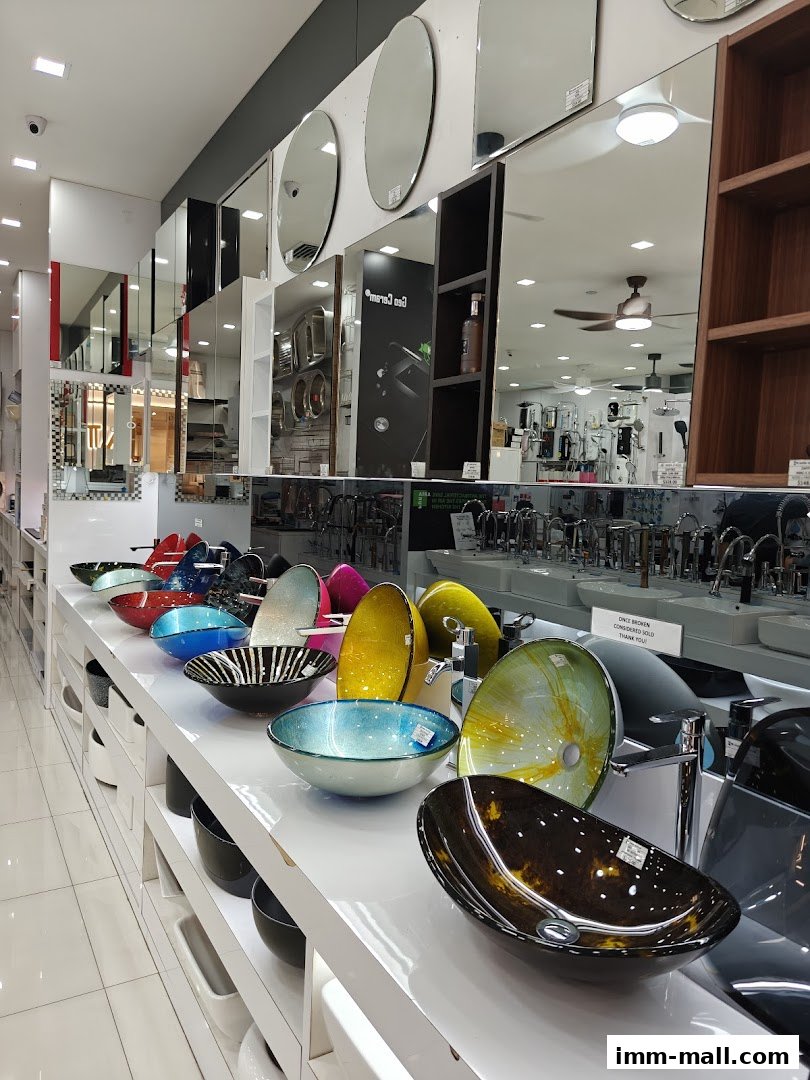 A retail store display featuring a variety of decorative glass sinks and bathroom fixtures.