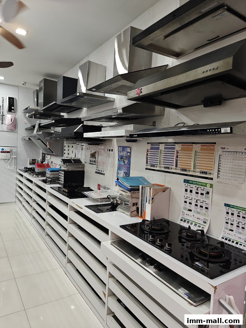 A retail store displaying various kitchen appliances, including range hoods and stovetops.