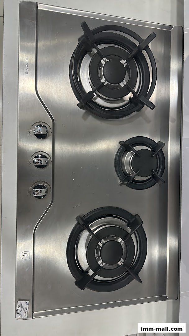 A close-up view of a stainless steel gas hob with three burners and control knobs.