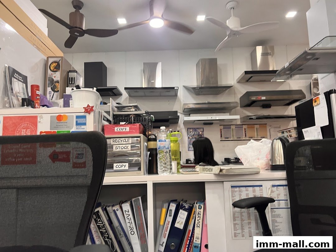 Interior view of a shop displaying kitchen appliances like range hoods and ceiling fans.