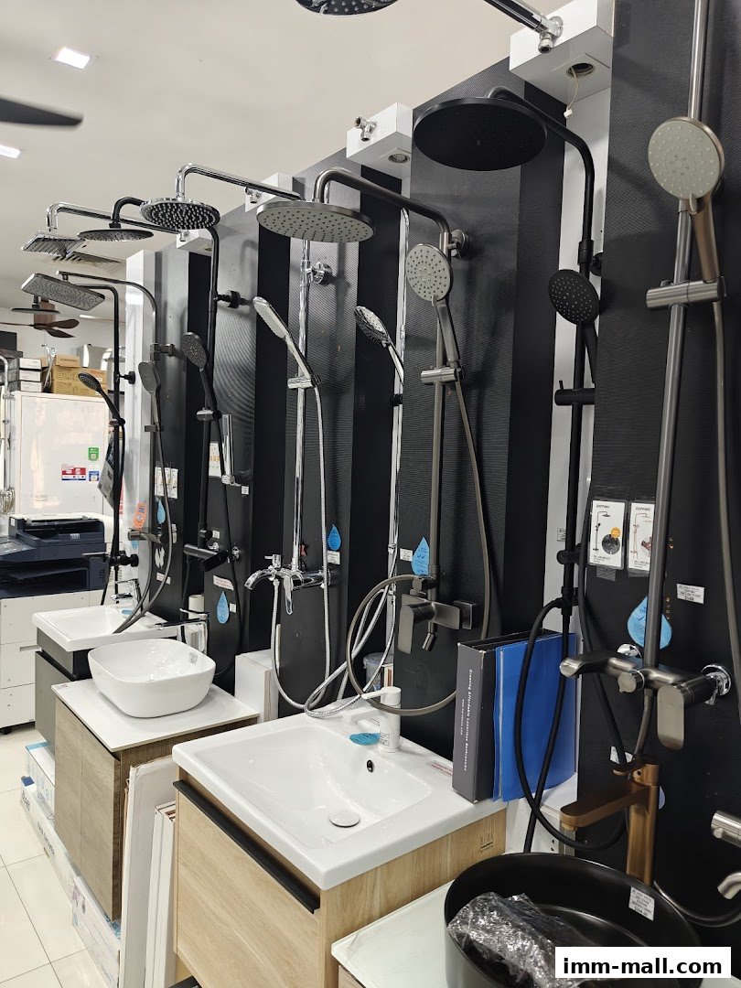 A display of modern bathroom sinks and shower fixtures in a retail store.