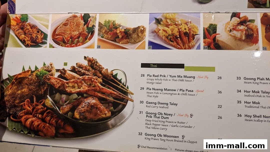 A menu featuring Thai dishes with images of seafood and grilled items.