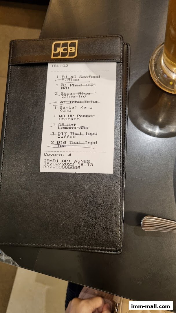 A receipt from Bali Thai IMM showing a table order with various food and drink items.