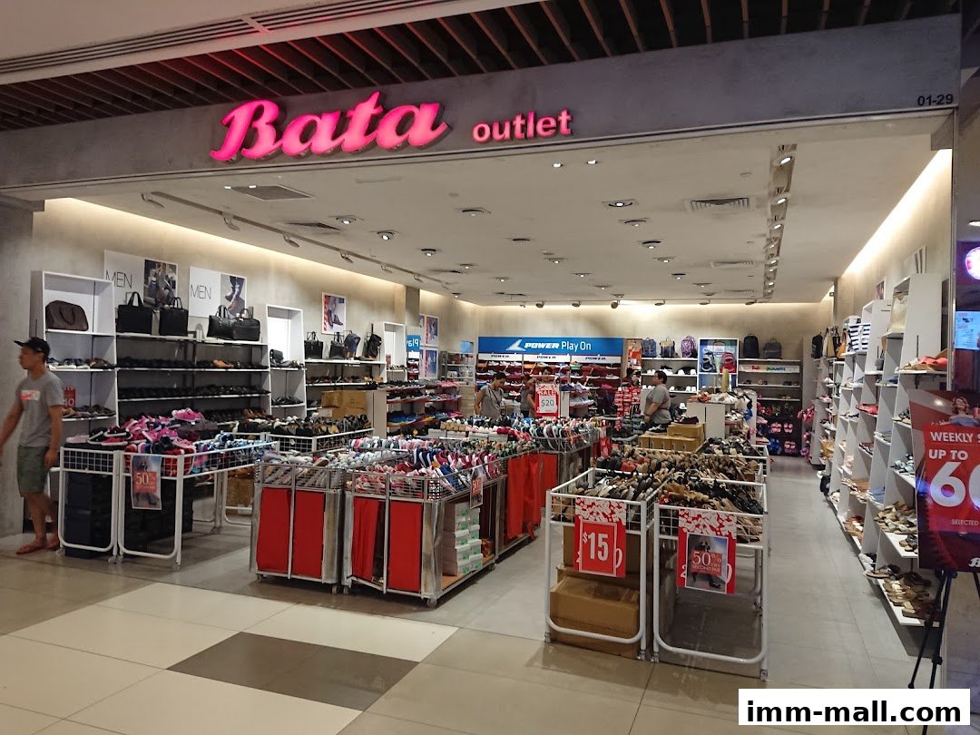 Interior view of a Bata shoe store showcasing various footwear and bags on display.