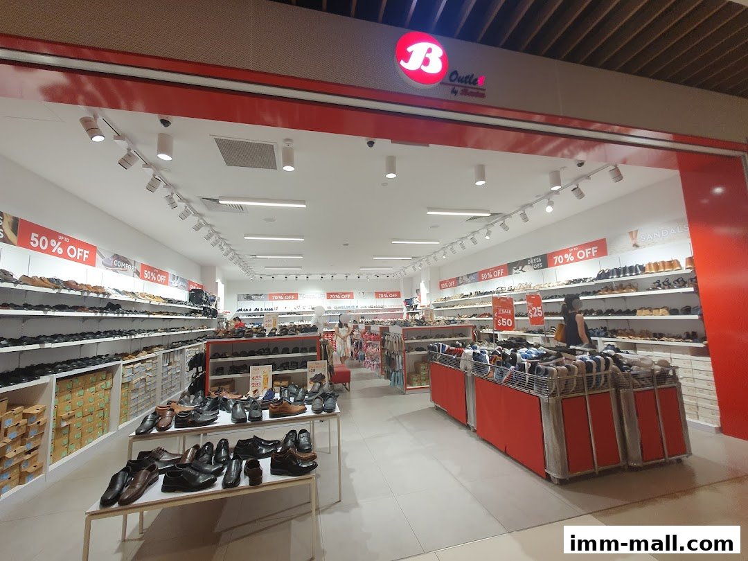 Interior view of a Bata shoe store with shelves full of shoes and sale signs.