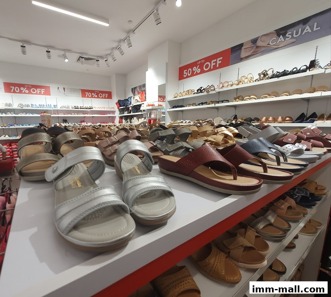 A wide selection of stylish sandals and footwear displayed on shelves in a Bata shoe store.