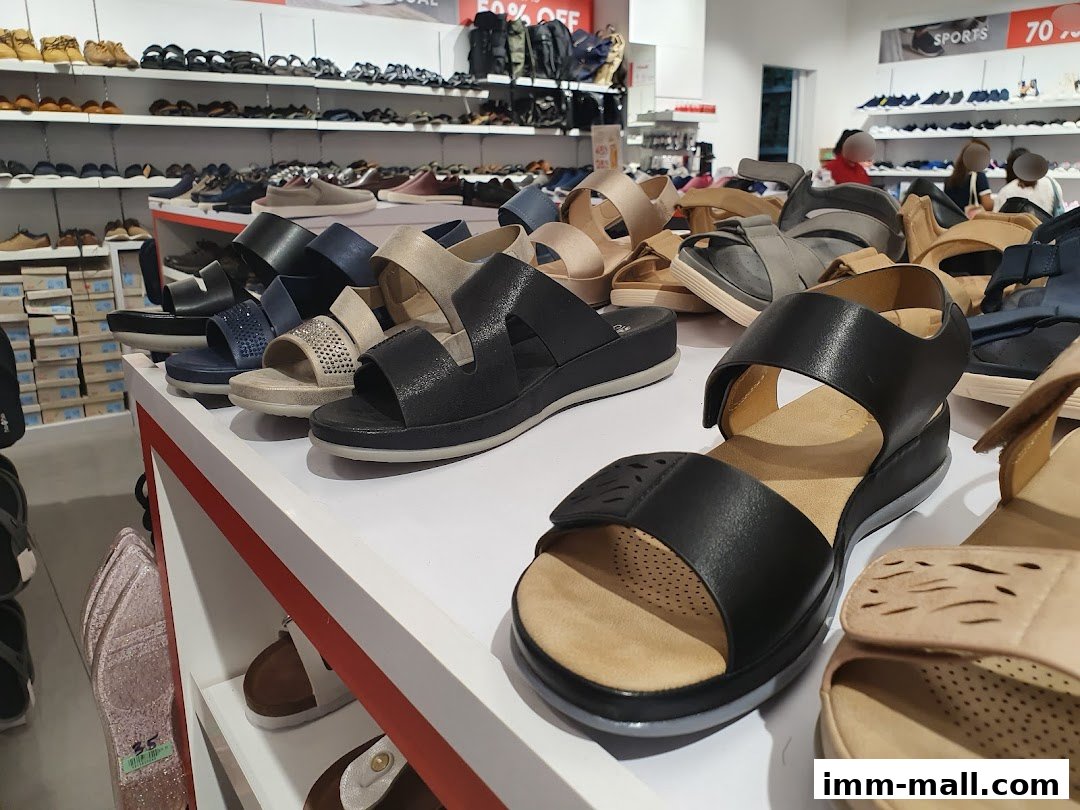 A display of various women's sandals and shoes on shelves inside a Bata store.