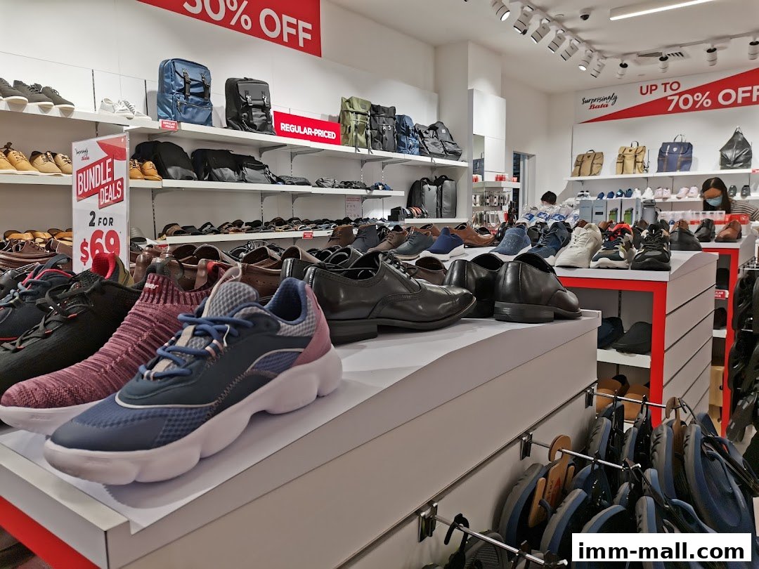 Interior view of a Bata shoe store showcasing various footwear and bags with sale signs.