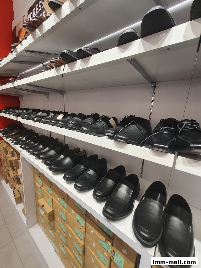 A wide selection of men's dress shoes displayed on shelves and in boxes.