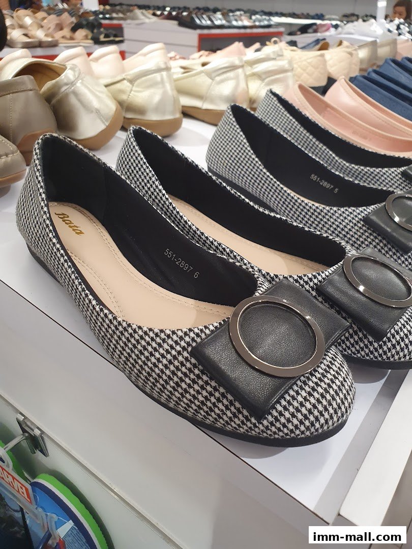 A display of stylish flat shoes with houndstooth pattern and decorative buckles at Bata.