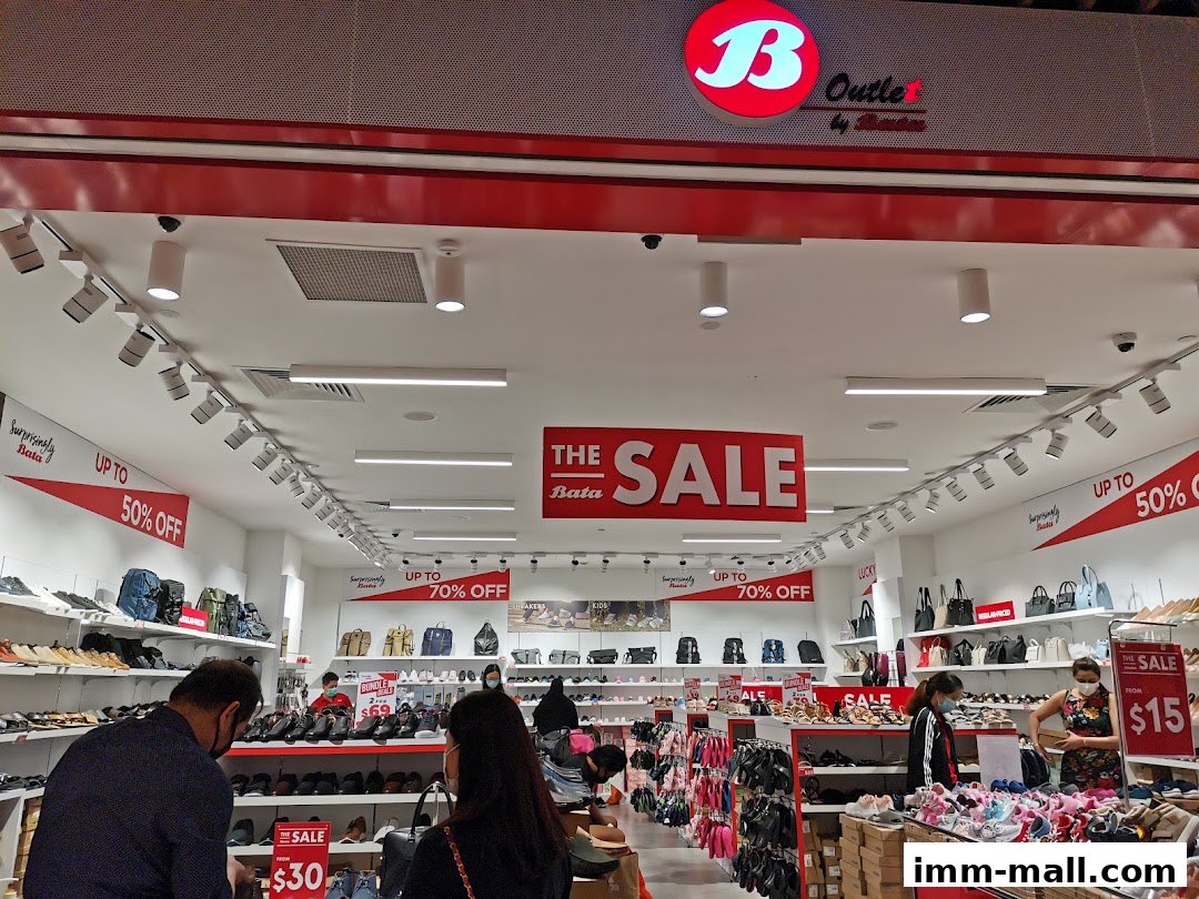 Interior view of a Bata shoe store with sale signs and shelves of footwear.