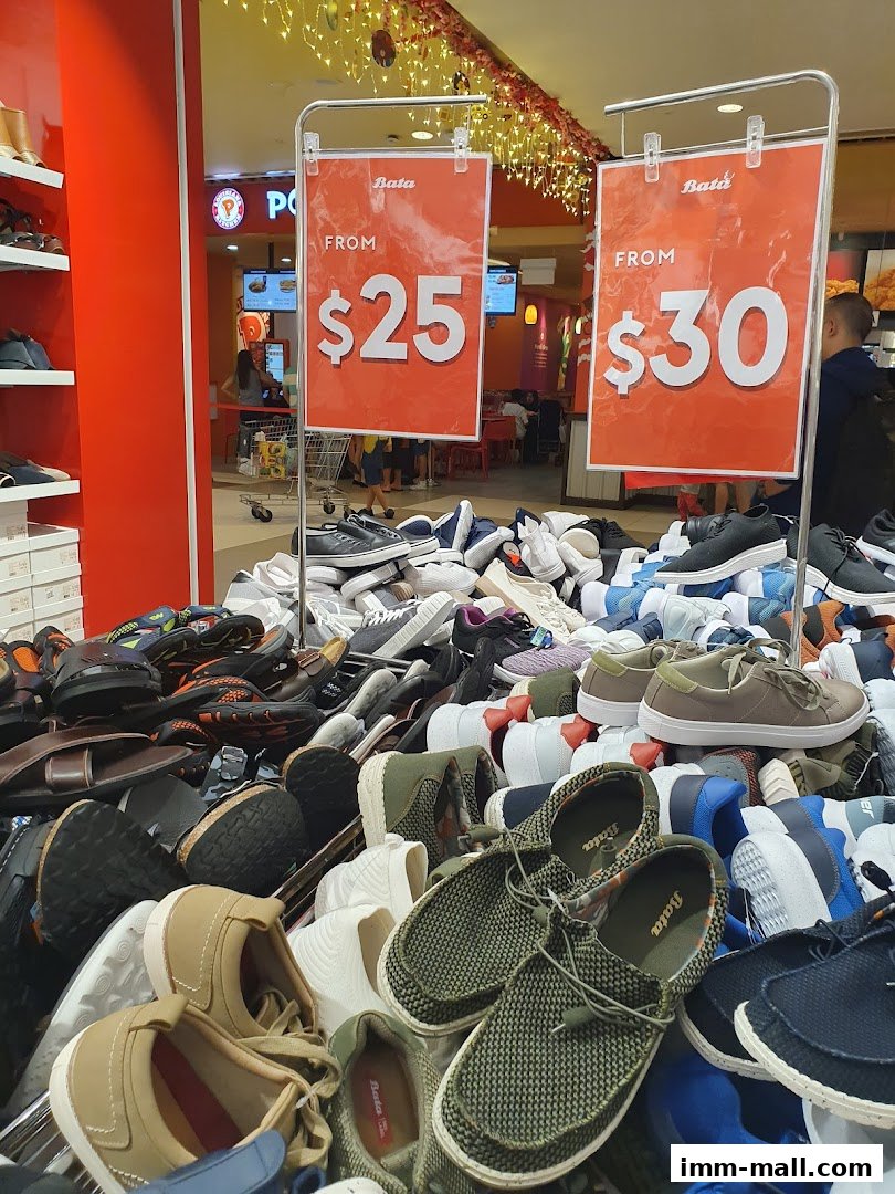 A large display of Bata shoes with sale signs indicating prices starting from $25 and $30.