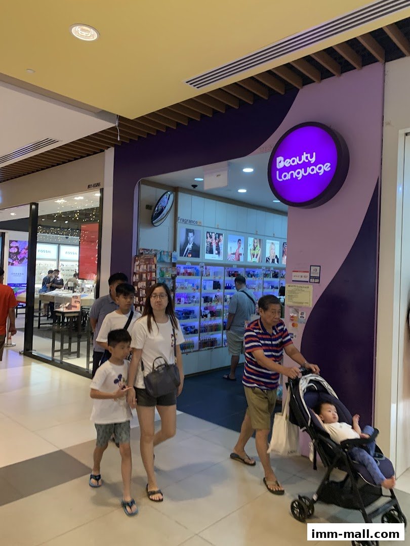 People walking past the Beauty Language shop entrance in a mall.