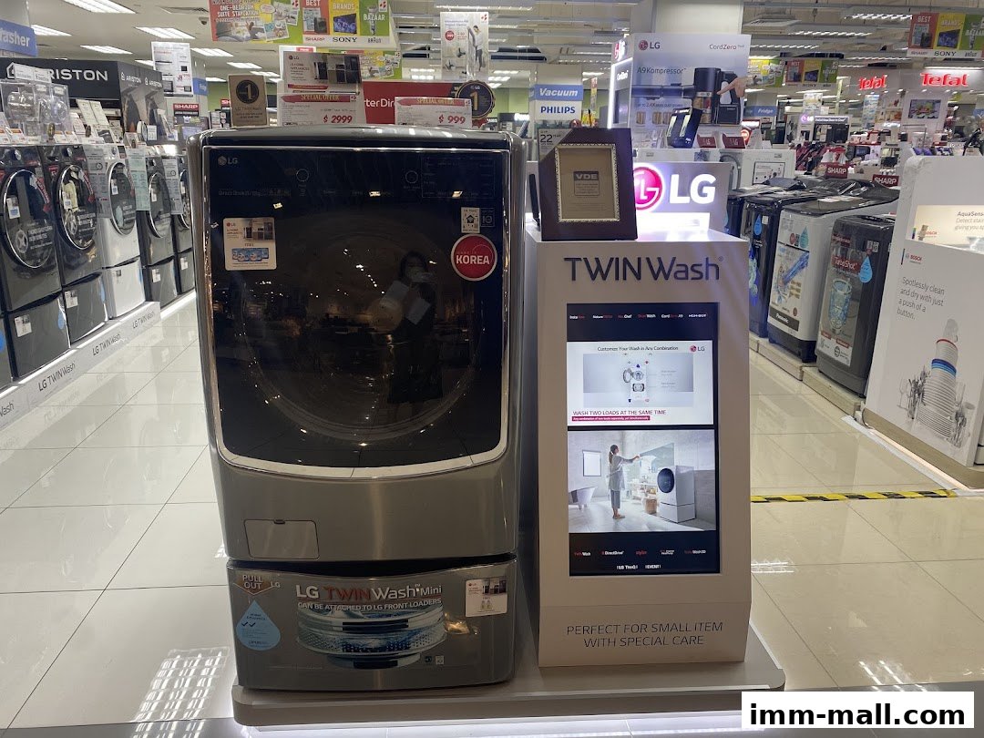 An electronics store interior showcasing LG washing machines and other appliances.