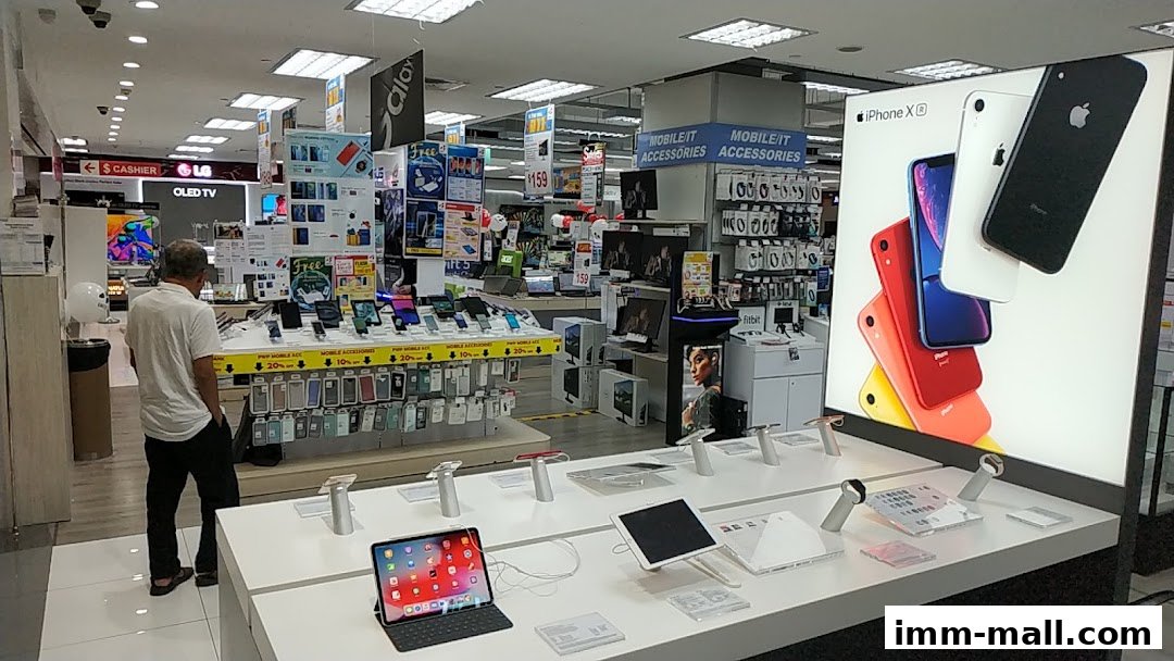 Interior of an electronics store with displays of phones, tablets, and accessories.