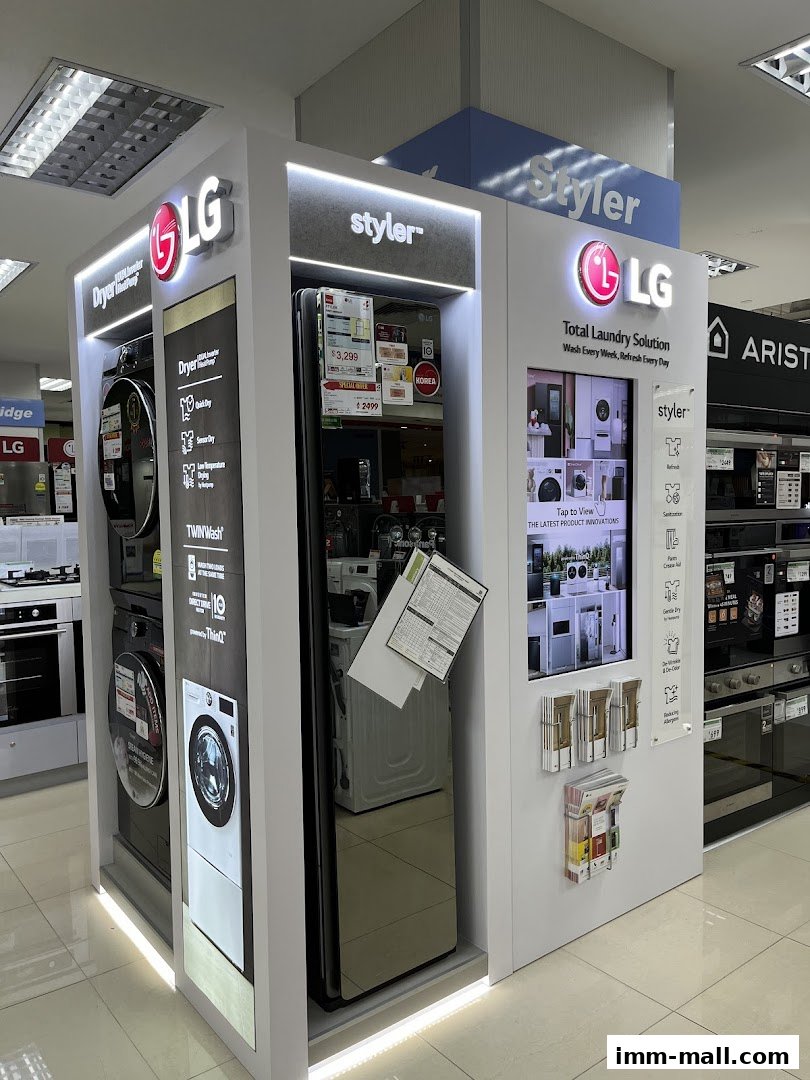 LG laundry appliances, including dryers and a Styler, are displayed in a retail store.