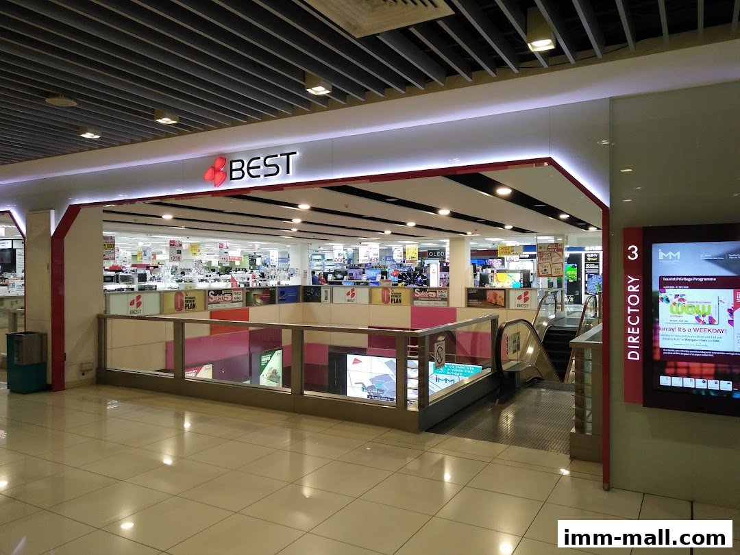 The entrance to a Best Denki electronics store with displays of various products visible inside.