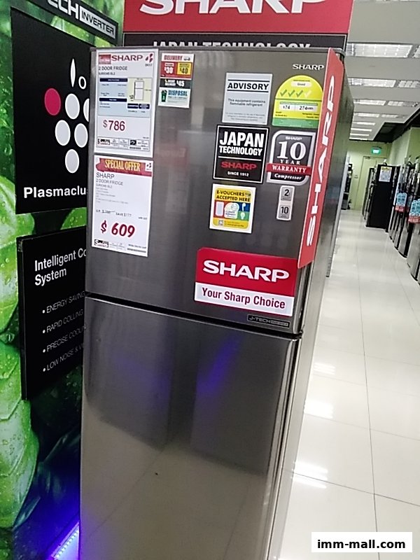 A Sharp 2-door refrigerator with special offer pricing and various product information stickers.