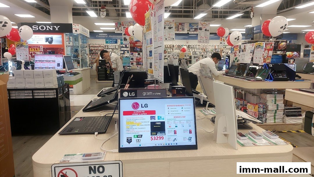 Interior of an electronics store with various brands and products on display.