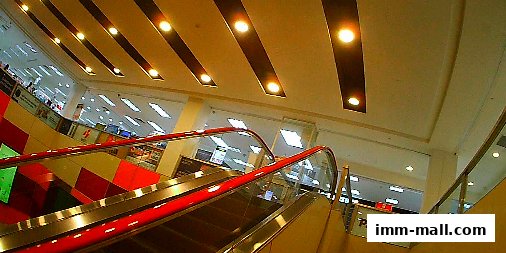 Escalators leading up to a brightly lit electronics store with Panasonic branding.