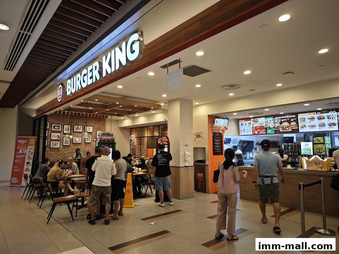 Burger King restaurant interior with customers ordering and dining.